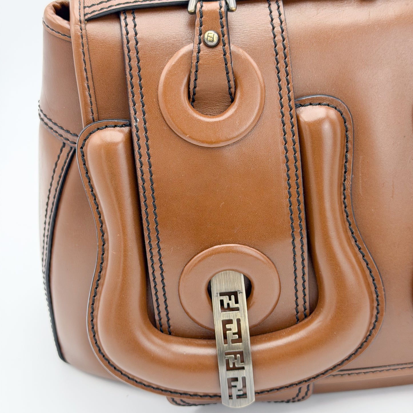 Fendi FF buckle hardware close up on tan leather