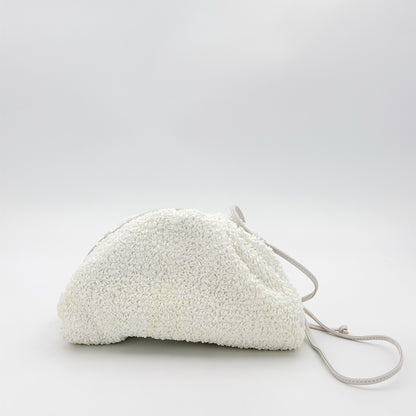 Bottega Veneta raffia pouch front view showing texture and strap