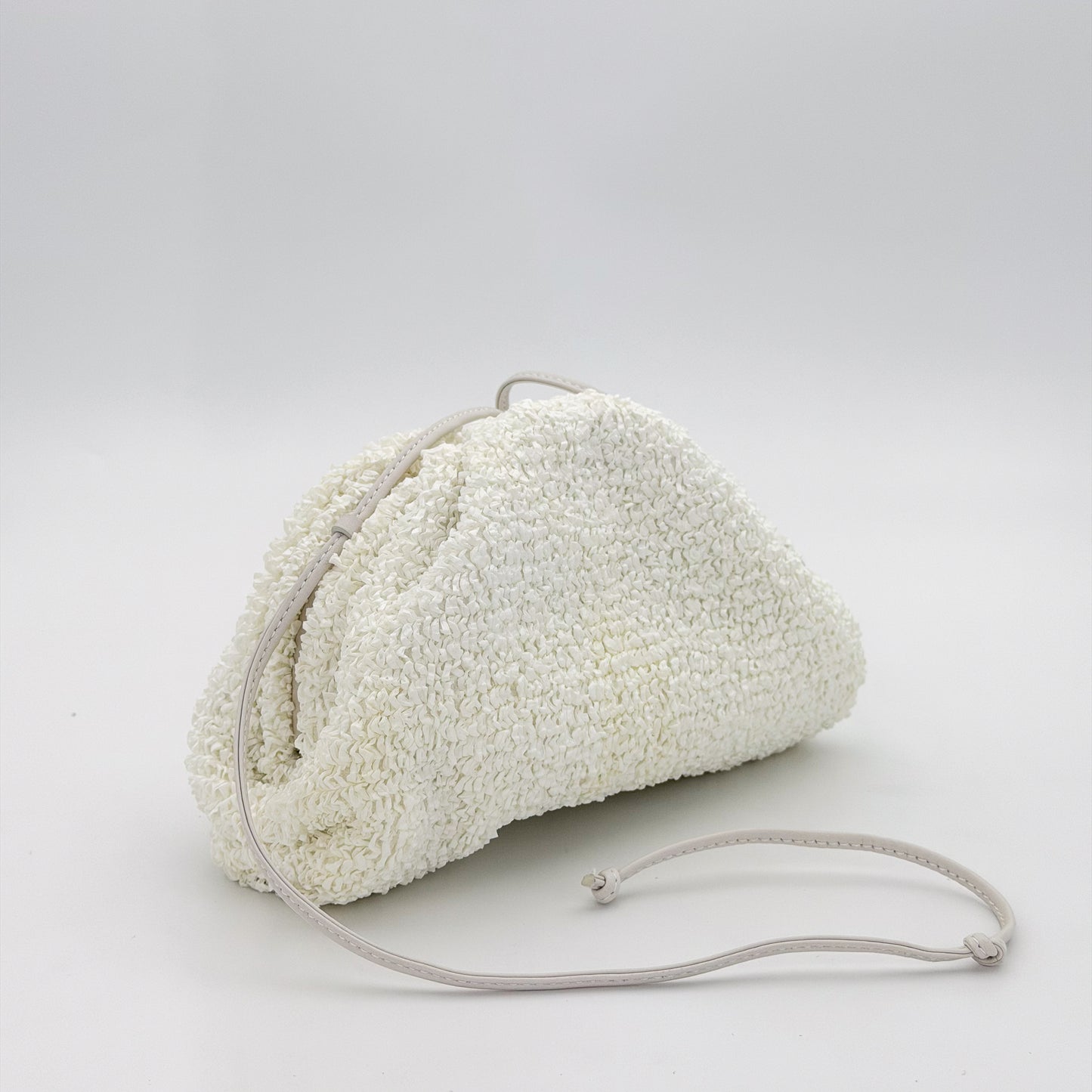 Bottega Veneta Mini Pouch front angled view with knotted leather strap