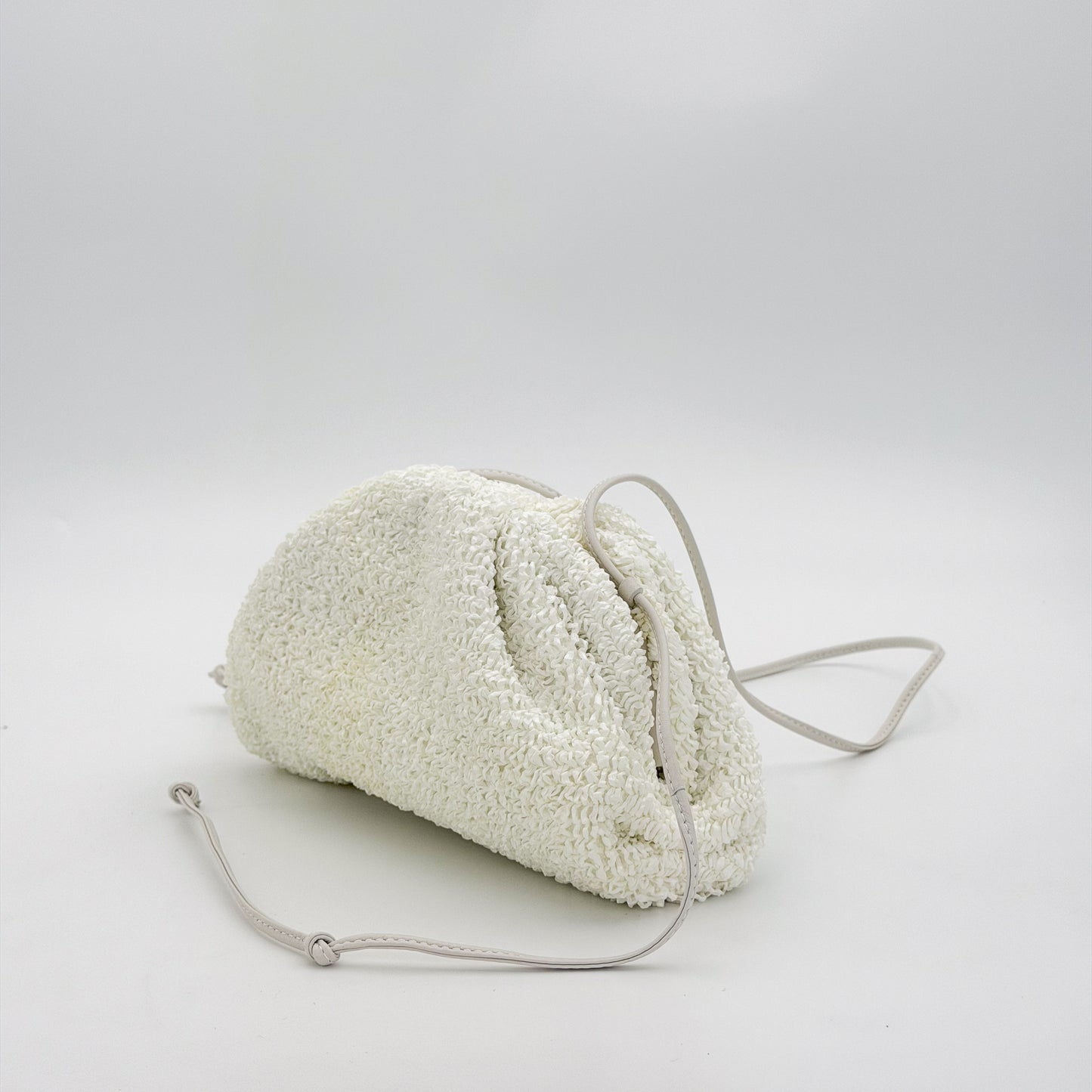 Bottega Veneta Mini Pouch front angled view with knotted leather strap