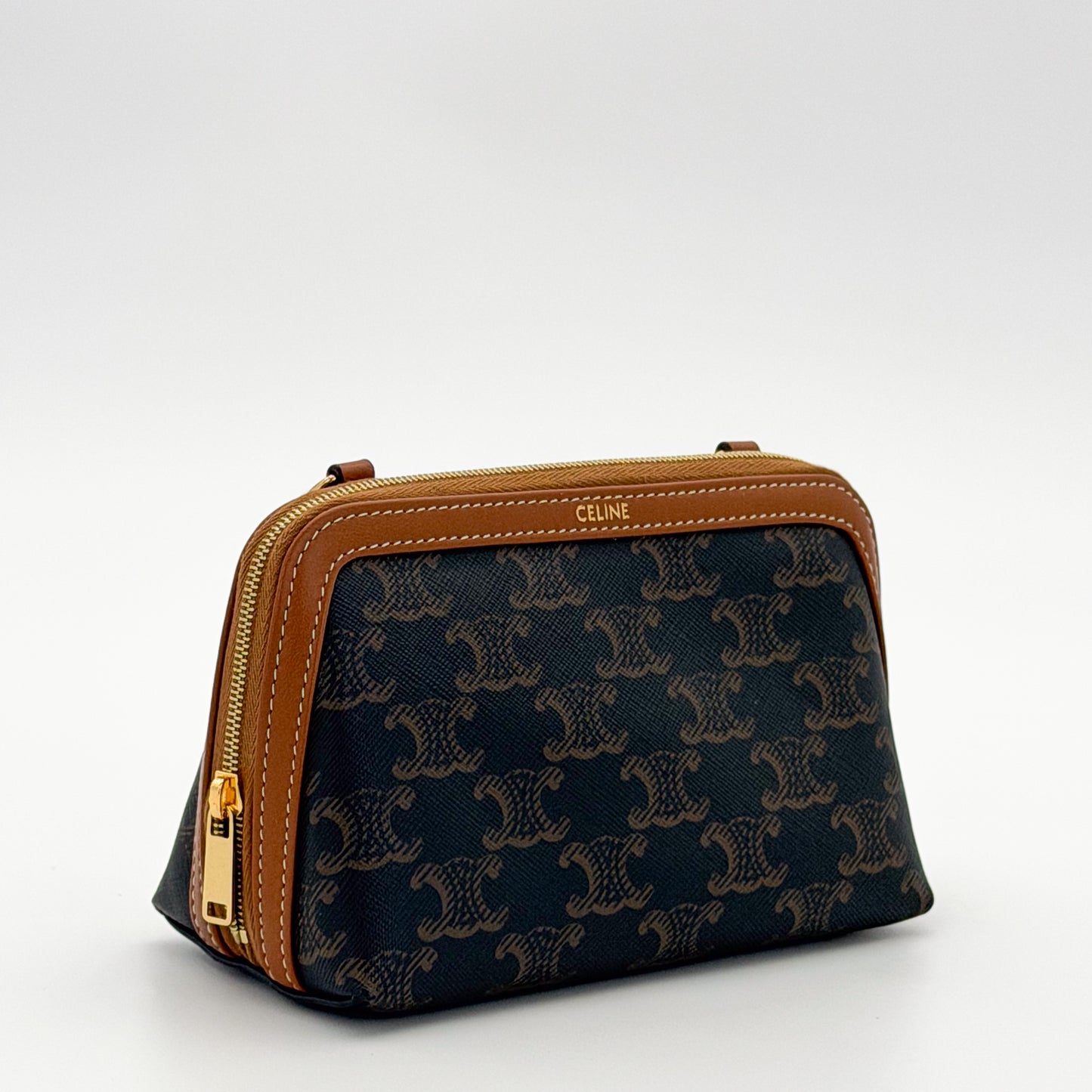Brand new Celine Triomphe clutch angled view with tan leather trim and zip