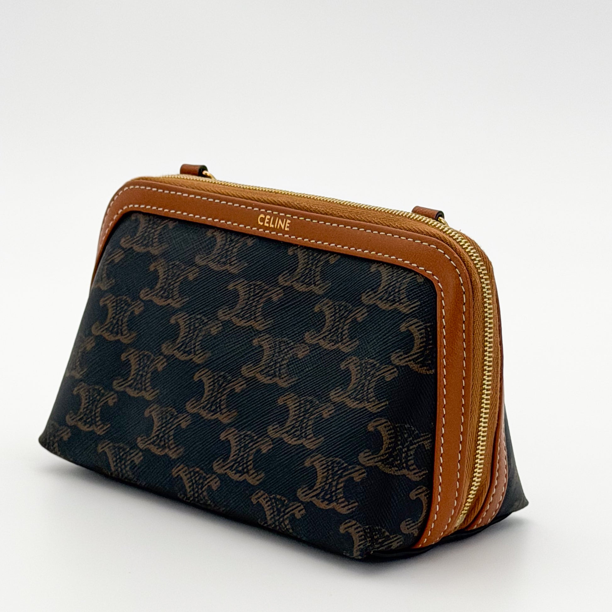 Celine Cuir Triomphe clutch side view showing CELINE debossed leather trim