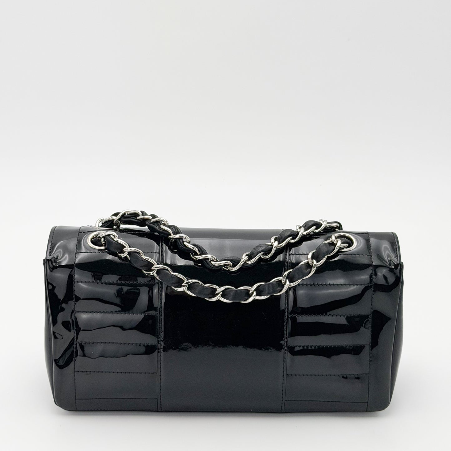 Vintage preloved Chanel vertical stitch black patent leather flap bag circa 2005, back view