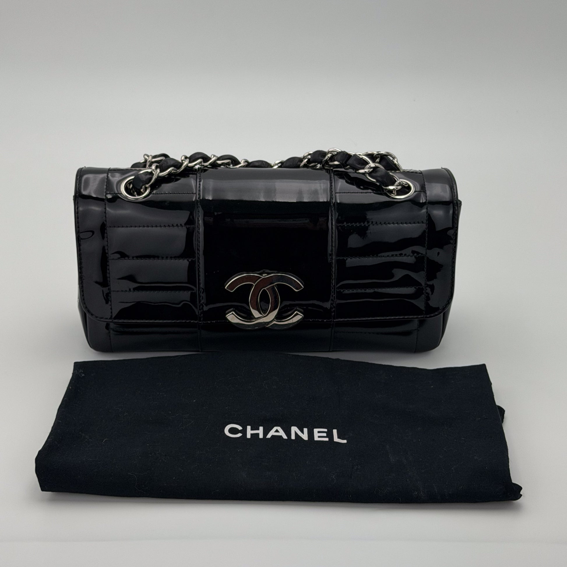 Interior of preloved Chanel vertical stitch flap bag, printed Chanel jacquard fabric lining and Made in France tag