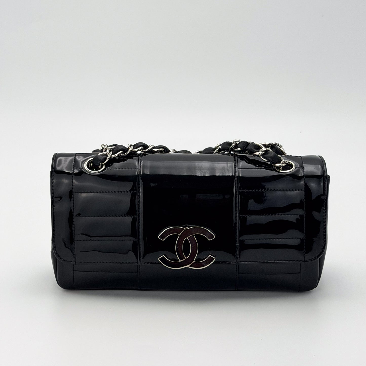 Vintage preloved Chanel vertical stitch black patent leather flap bag circa 2005, front view 