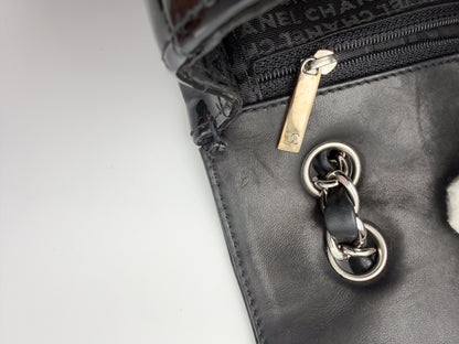 Vintage Chanel flap bag zipper pull branding and leather interior detail, silver hardware