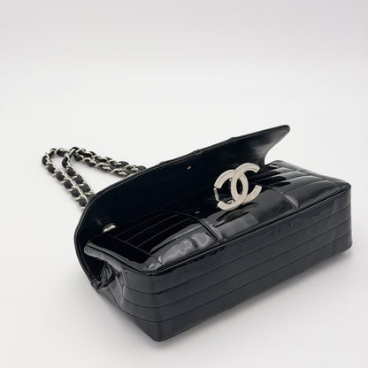 Second hand Chanel patent leather flap bag, vertical stitch detail, silver CC turnlock close-up