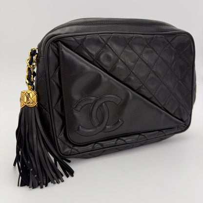 Vintage Chanel black quilted lambskin tassel camera bag front view with gold chain and CC logo