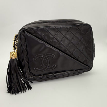 Vintage Chanel black quilted lambskin tassel camera bag front view with gold chain and CC logo