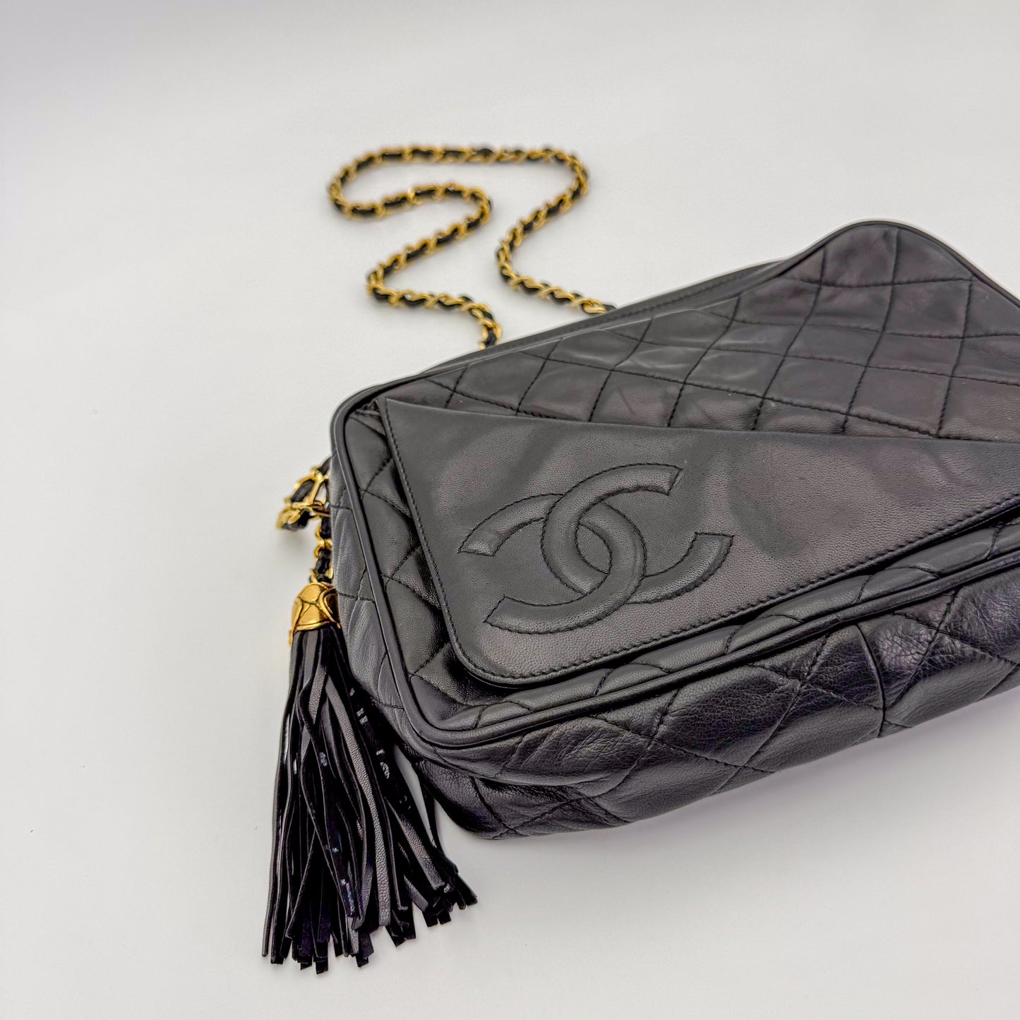 Vintage Chanel black quilted lambskin tassel camera bag Ariel and side view