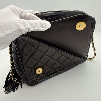 Vintage Chanel black quilted lambskin tassel camera bag front view with gold chain showing the front small pocket