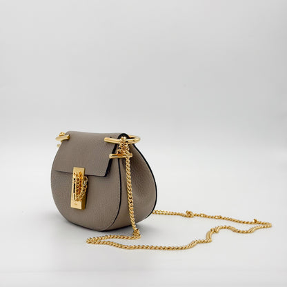 Used Chloé Mini Drew crossbody bag left side angled view showing saddle shape