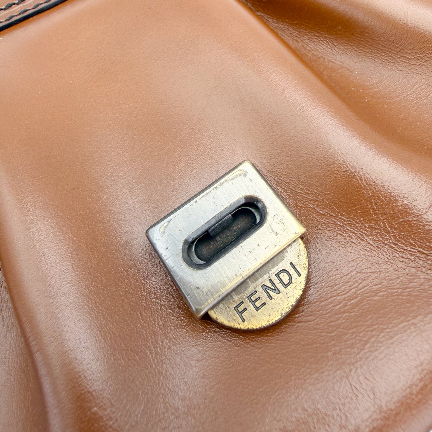  Fendi hardware close up showing engraved Fendi push-lock closure