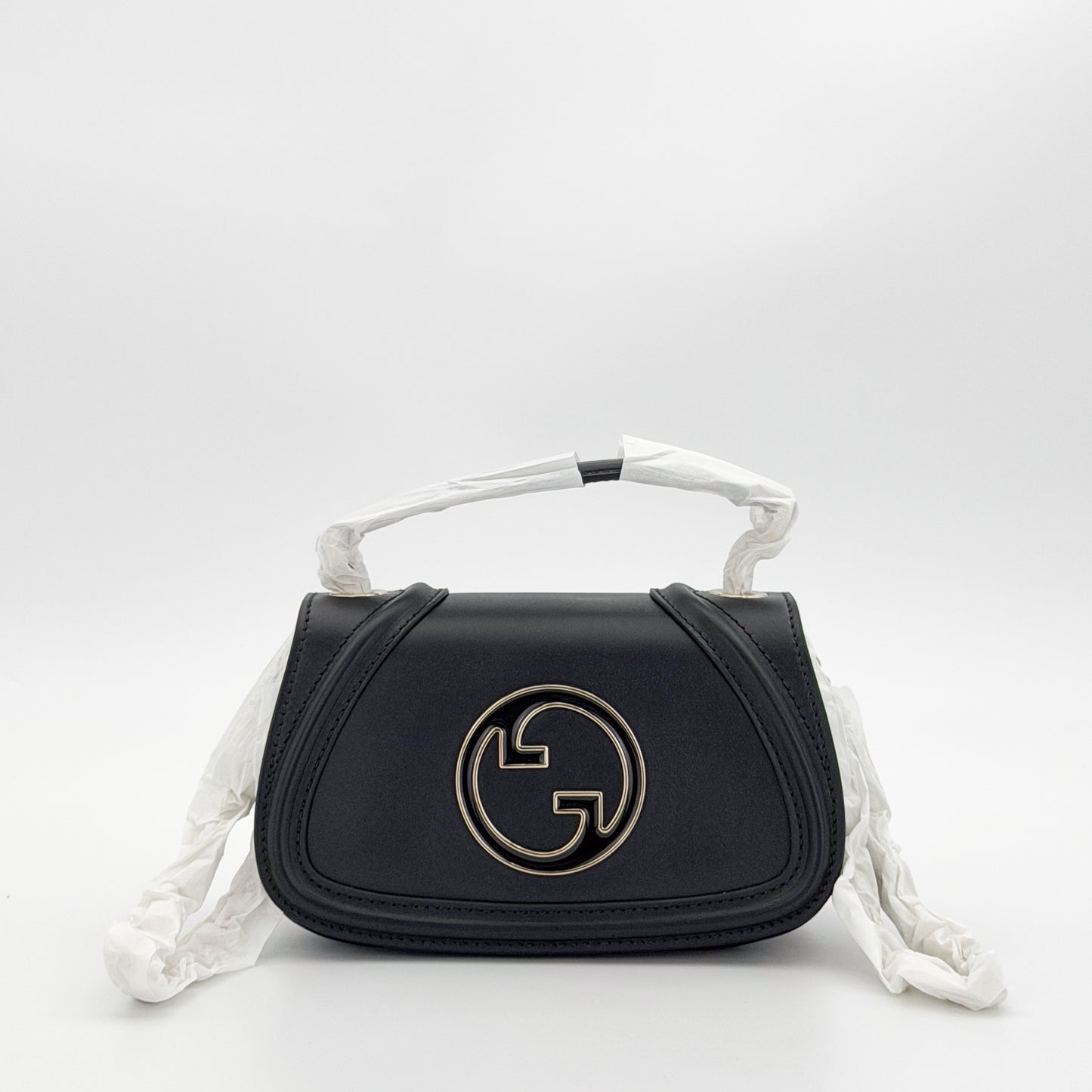 Unworn Gucci Blondie bag front view showing GG plaque and chain strap covered in original packaging