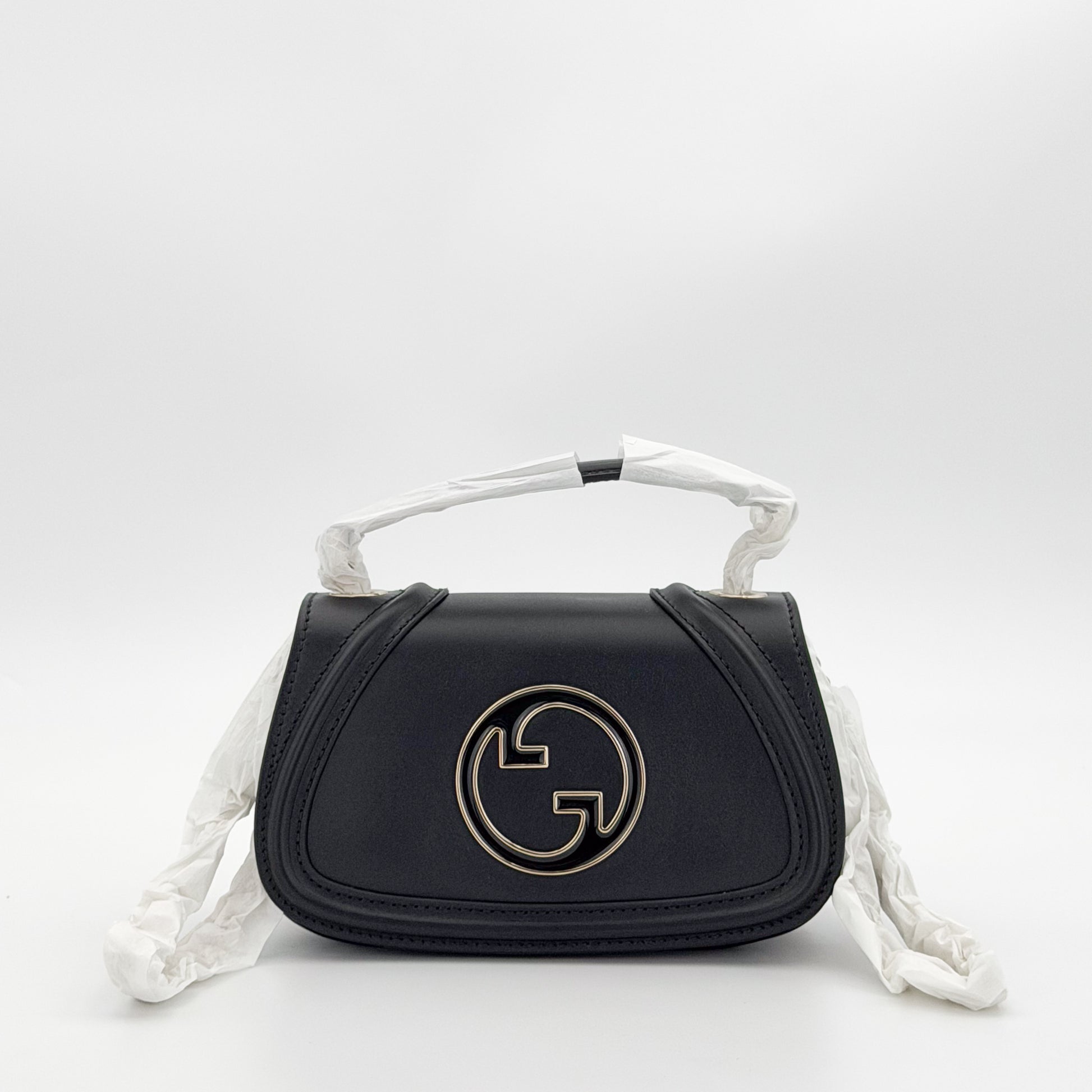 Unworn Gucci Blondie bag front view showing GG plaque and chain strap covered in original packaging