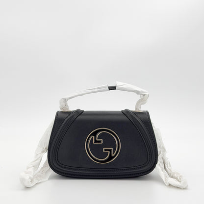 Unworn Gucci Blondie bag front view showing GG plaque and chain strap covered in original packaging