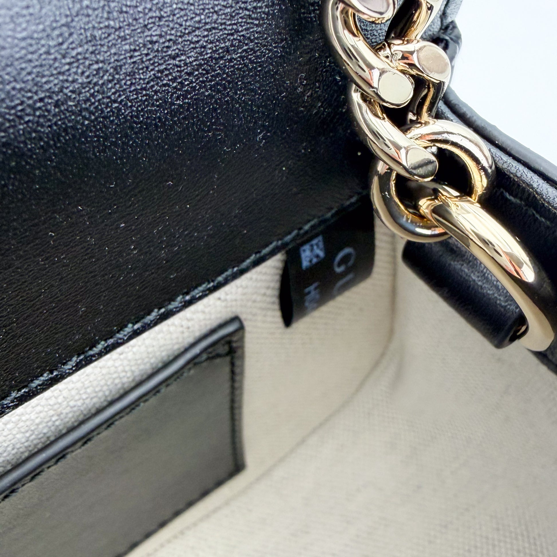 Gucci Blondie bag interior view showing cotton-linen lining and chain