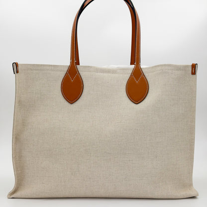 Brand new Gucci canvas tote back view showing natural canvas and leather handles