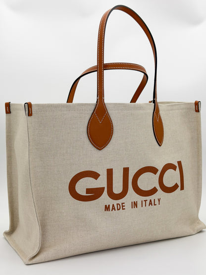 Brand new Gucci canvas tote back view showing natural canvas and leather handles