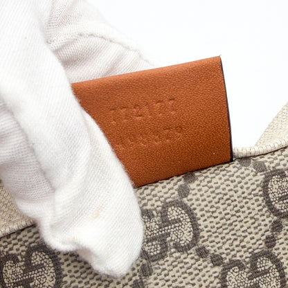 Unworn Gucci logo print tote corner detail showing leather trim stitching and serial number