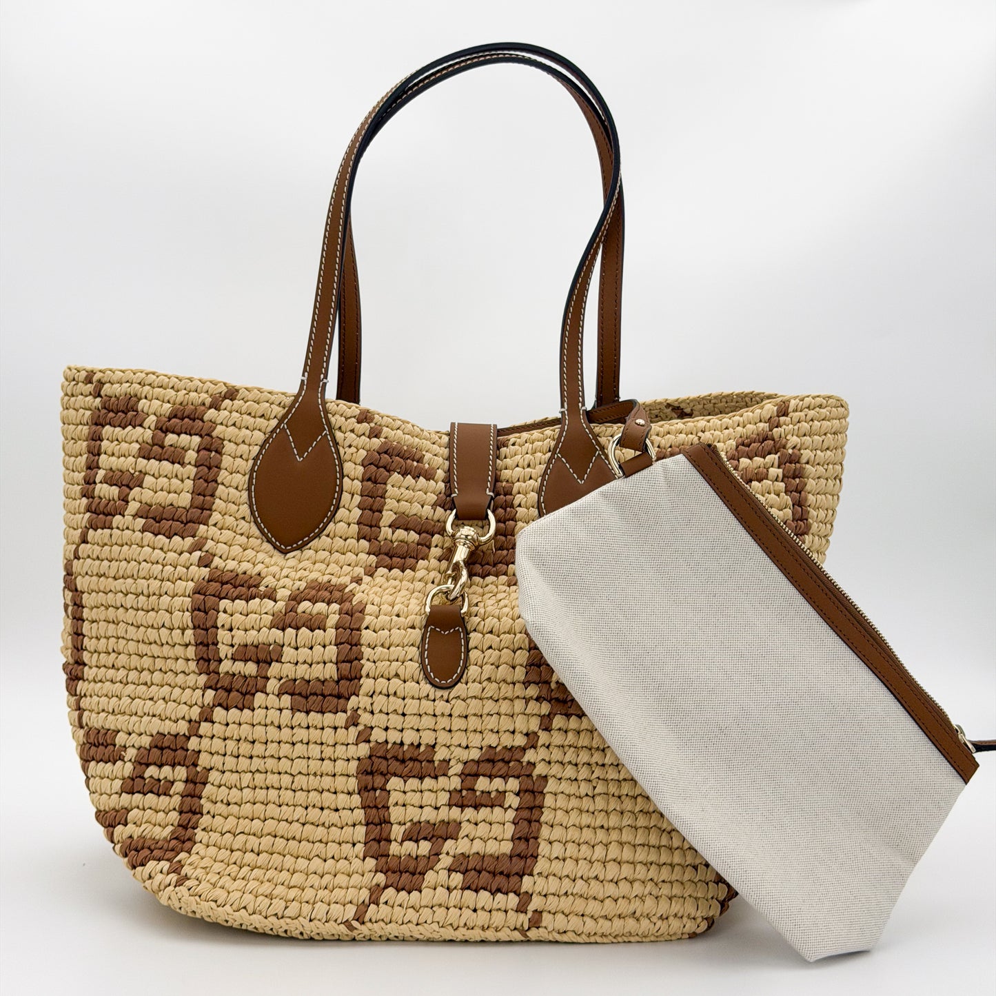 Brand new unworn Gucci GG raffia tote front view with woven pattern and leather trim pouch