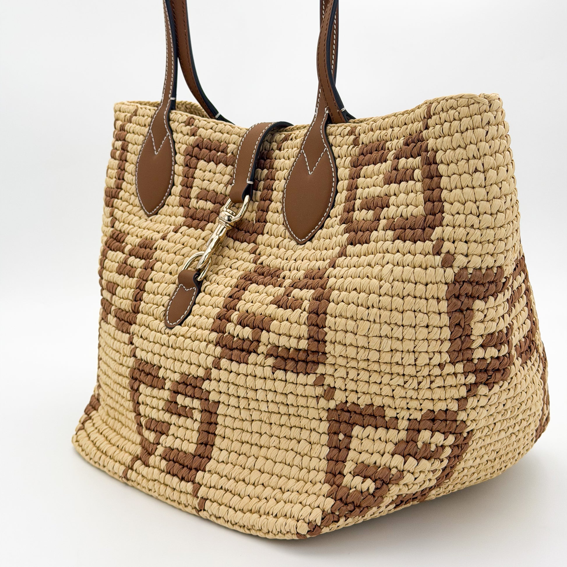 Gucci GG raffia tote left side view with gold-tone dog-hook hardware