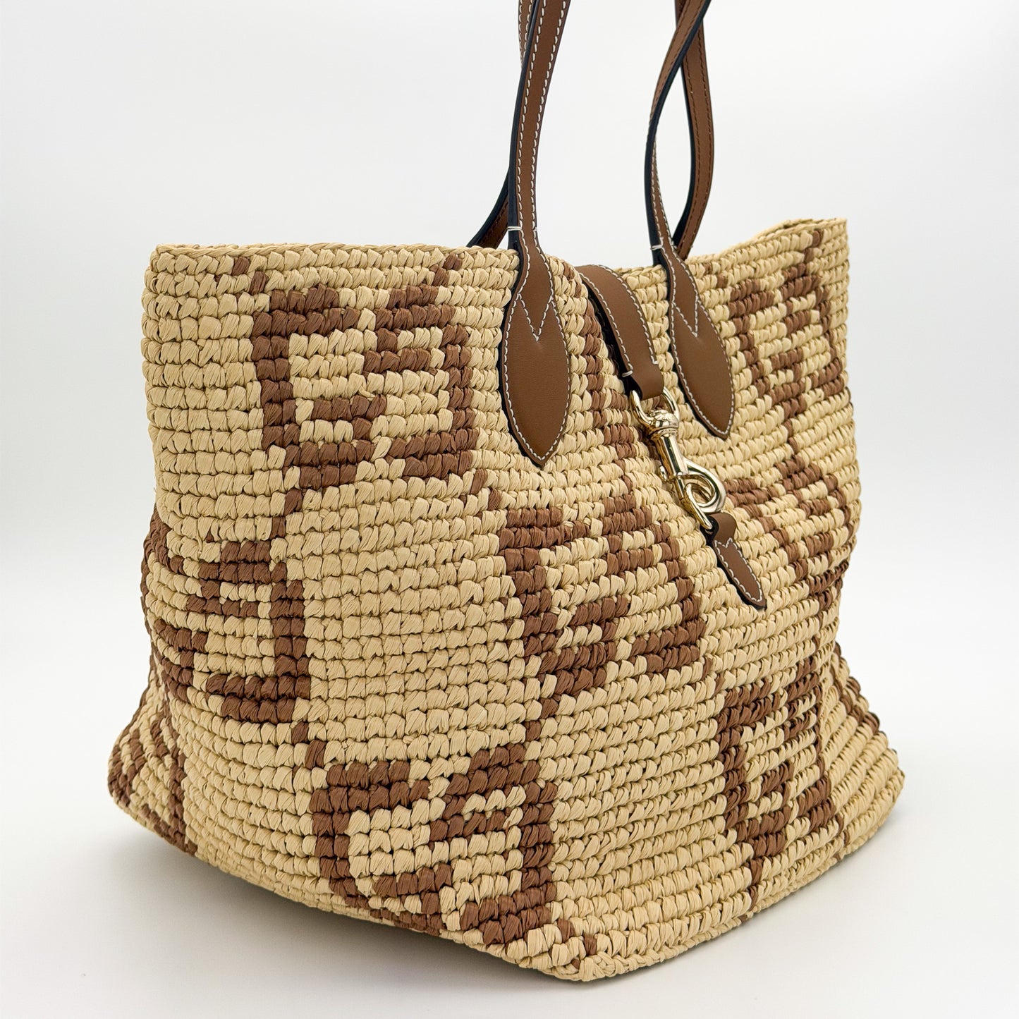 Gucci raffia tote right side view showing crochet weave and tan leather handles
