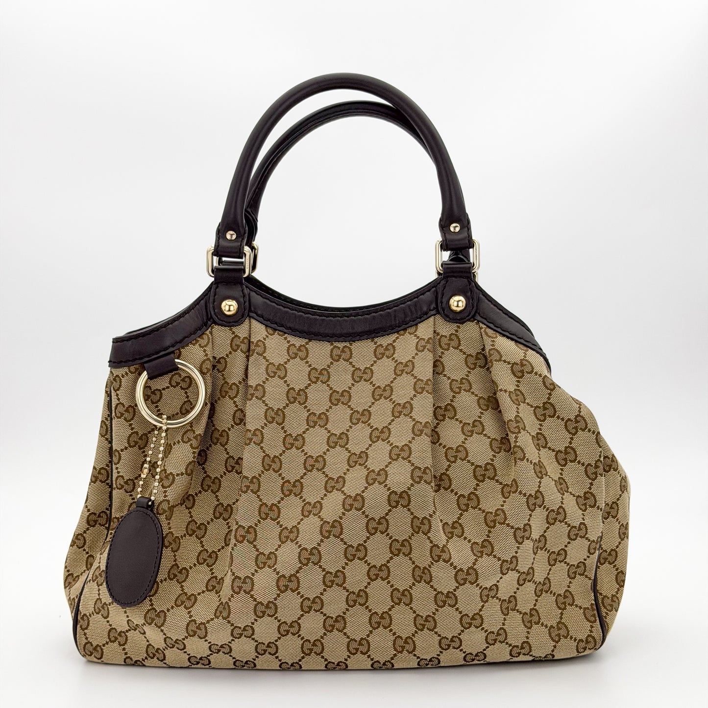 Brand new unworn Gucci Sukey GG canvas tote front view with leather trim and charm