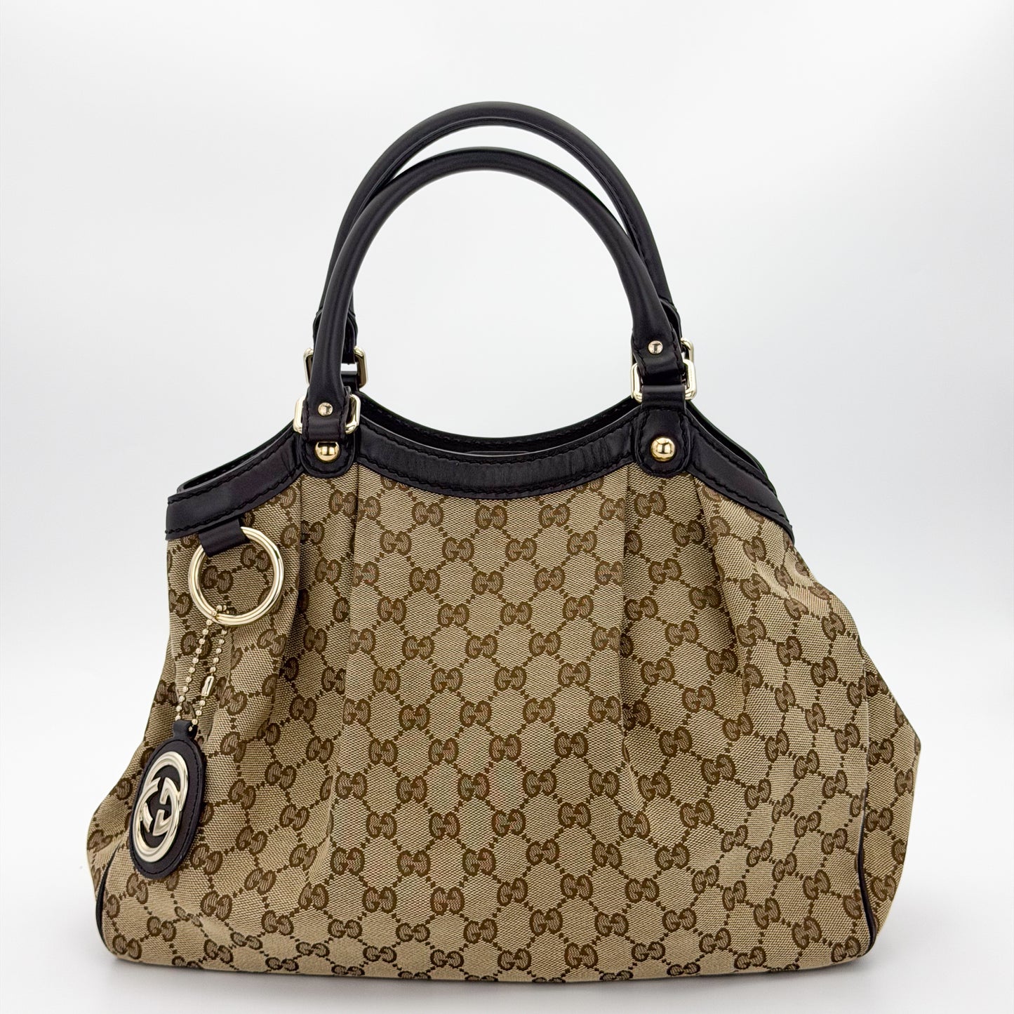 Brand new unworn Gucci Sukey GG canvas tote front view with leather trim and charm