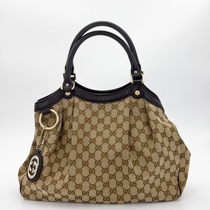 Brand new unworn Gucci Sukey GG canvas tote front view with leather trim and charm