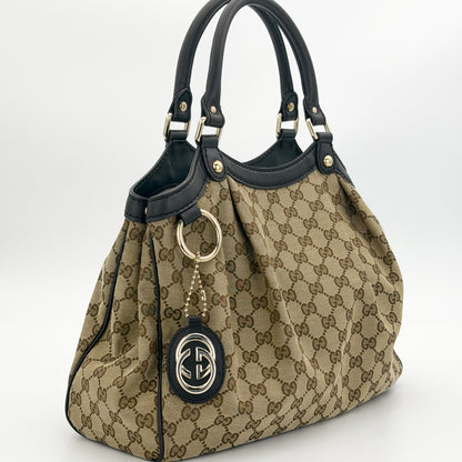 Gucci Sukey tote right side view showing pleated canvas and rolled handles
