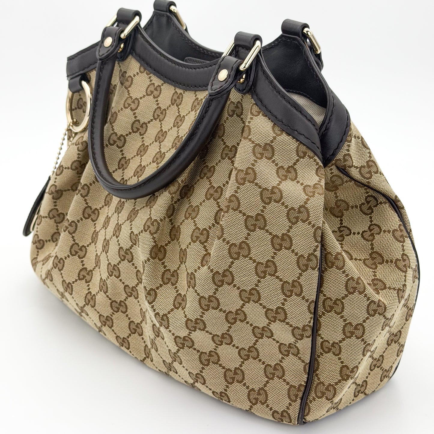 Gucci Sukey tote right side view showing pleated canvas and rolled handles