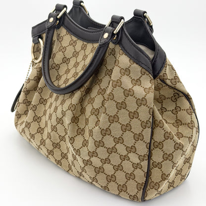 Gucci Sukey tote right side view showing pleated canvas and rolled handles