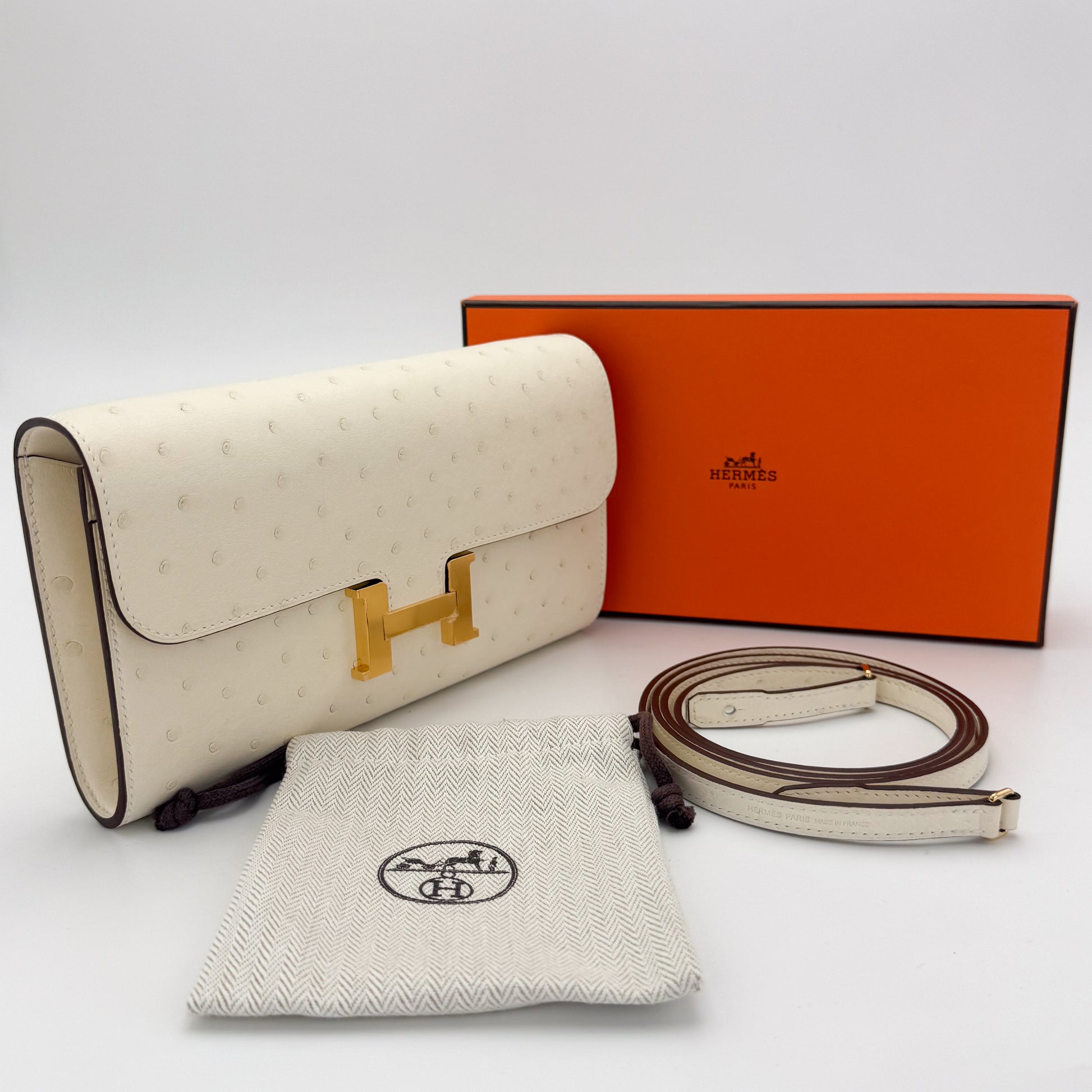 Brand new Hermès Constance To Go Nata ostrich with gold hardware — with original orange box, dust bag, and strap