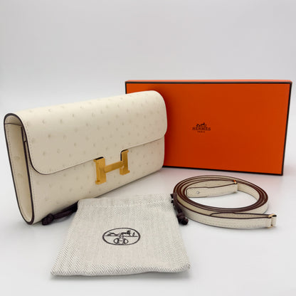 Brand new Hermès Constance To Go Nata ostrich with gold hardware — with original orange box, dust bag, and strap