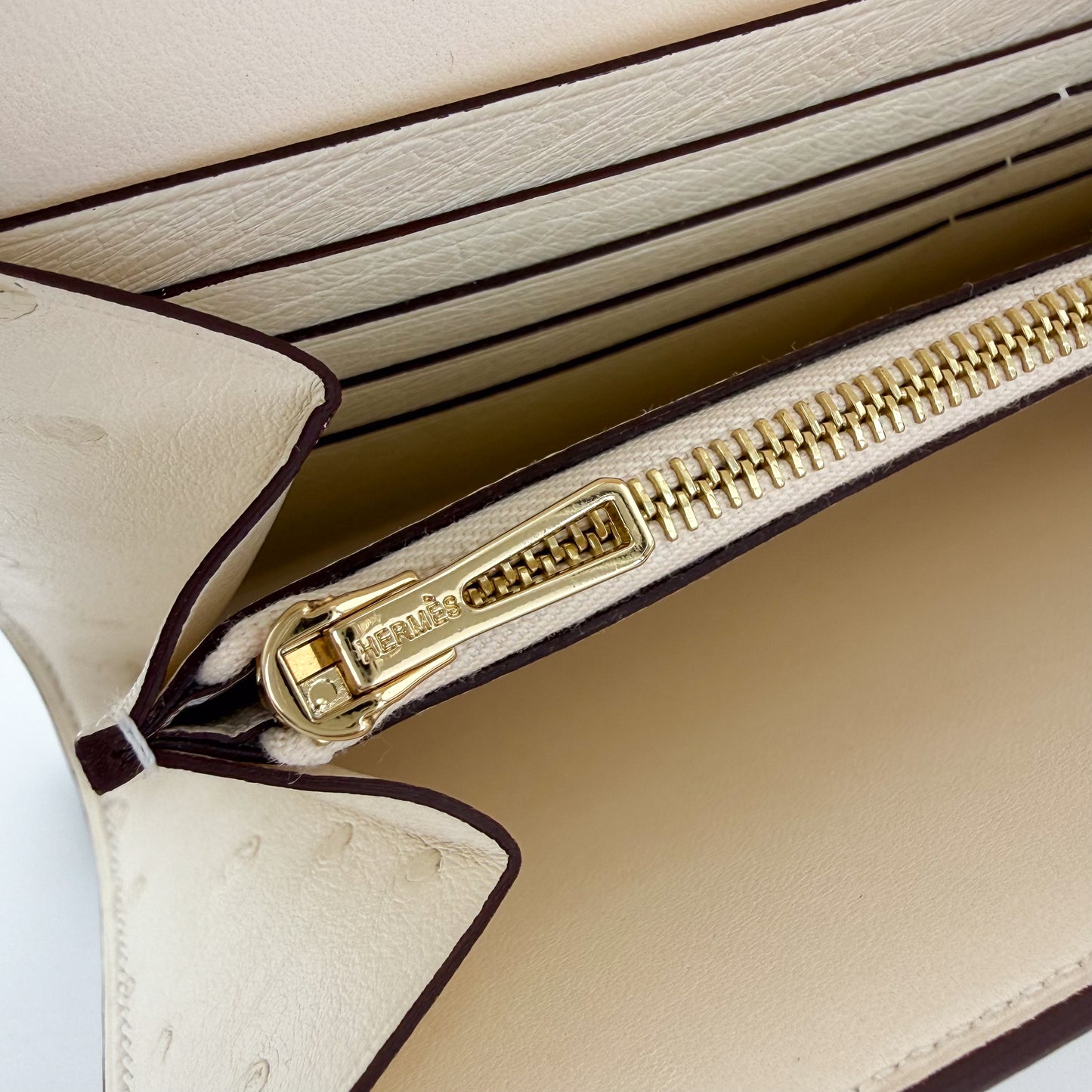 Hermes stamp on the gold hardware of a Hermes Constance to Go in Ostrich Nata