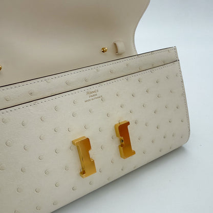 Detailed view of a brand new Hermès Constance To Go in Nata ostrich with gold hardware.