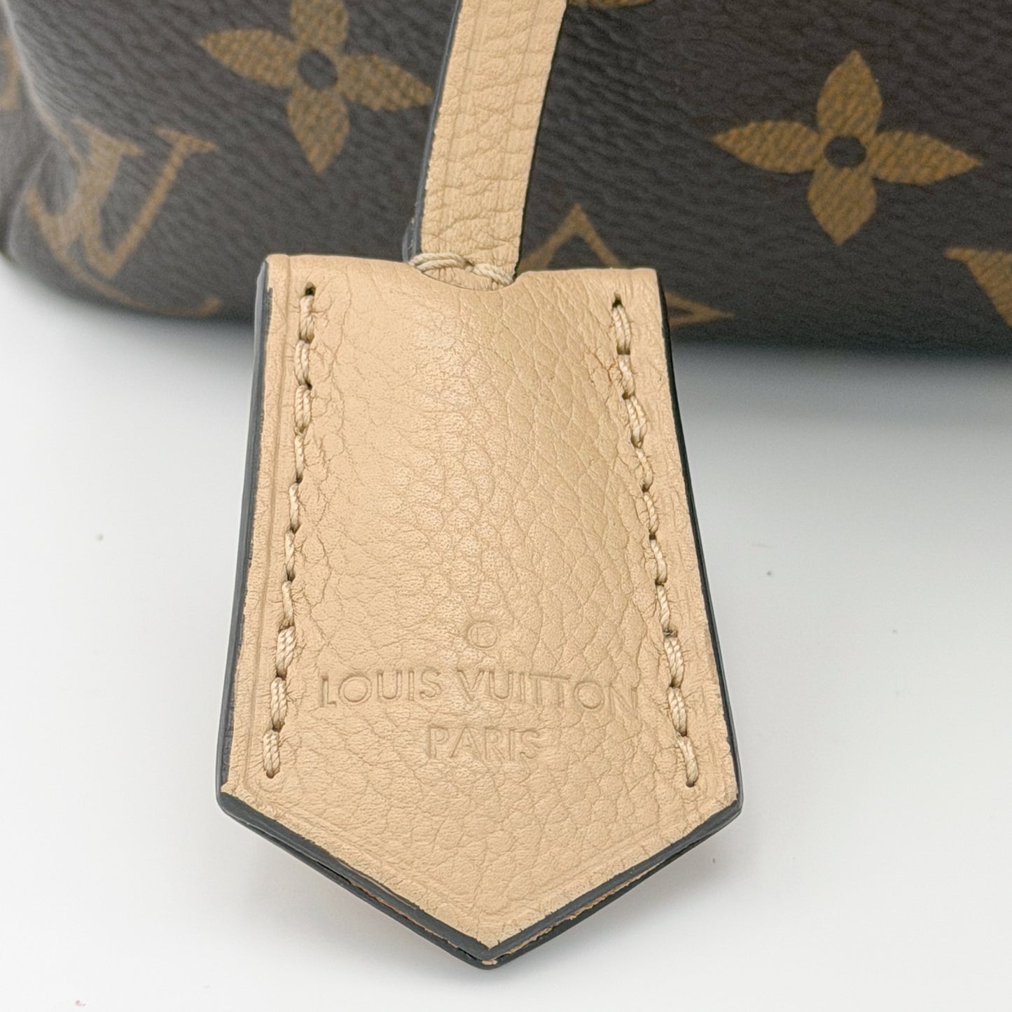 Second hand Louis Vuitton Pallas Shopper brand stamp detail on Dune leather trim