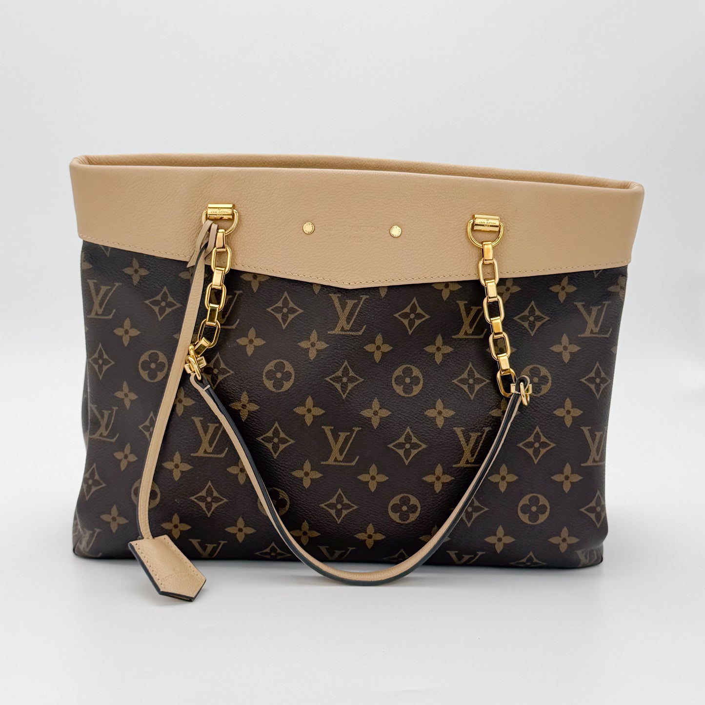 Used Louis Vuitton Pallas Shopper brand tag close up with embossed logo