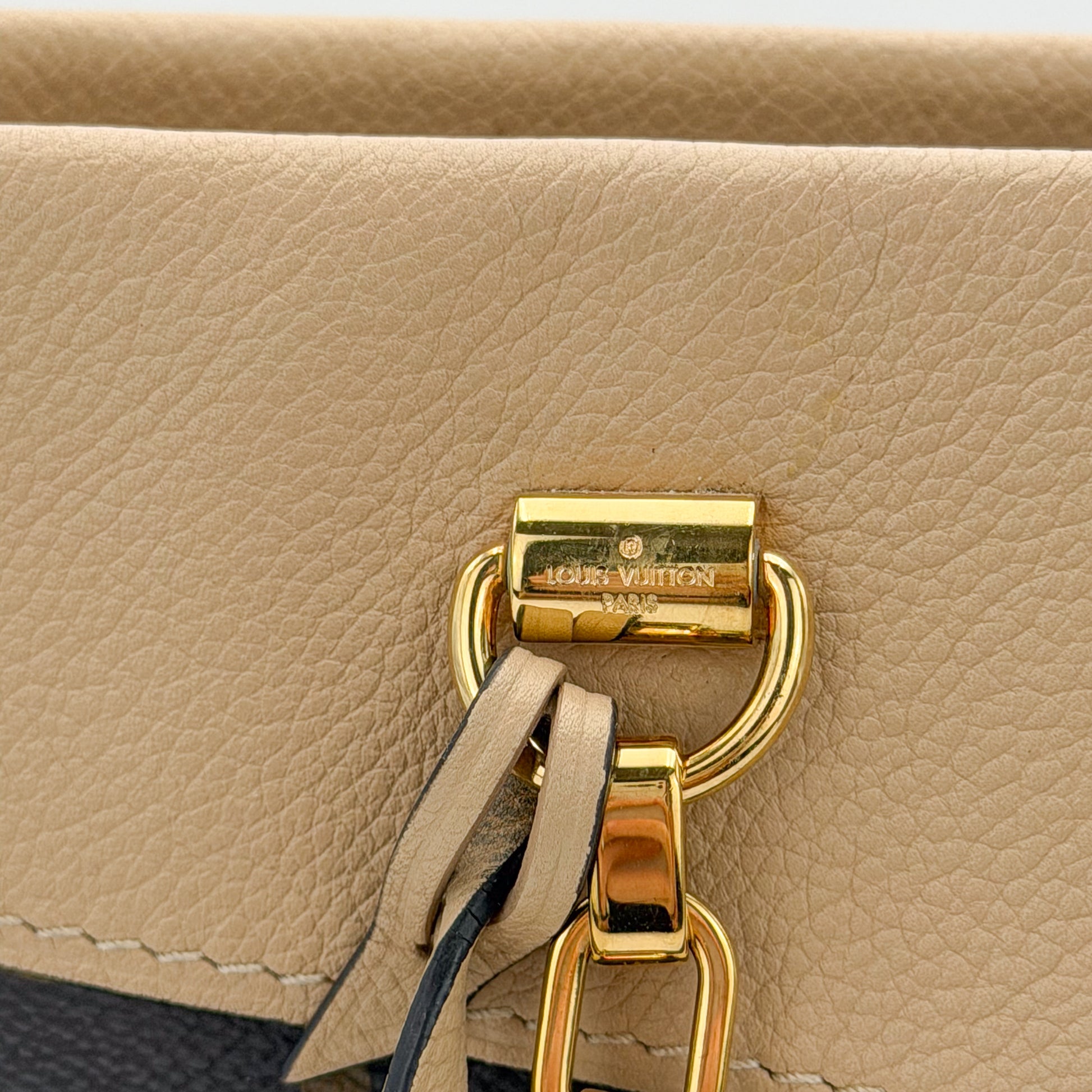 Used Louis Vuitton Pallas Shopper gold hardware close up on Dune leather trim