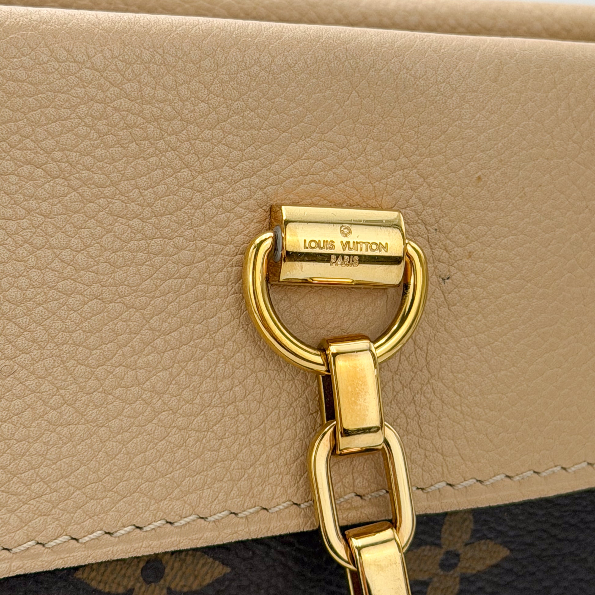 Used Louis Vuitton Pallas Shopper gold hardware close up on Dune leather trim