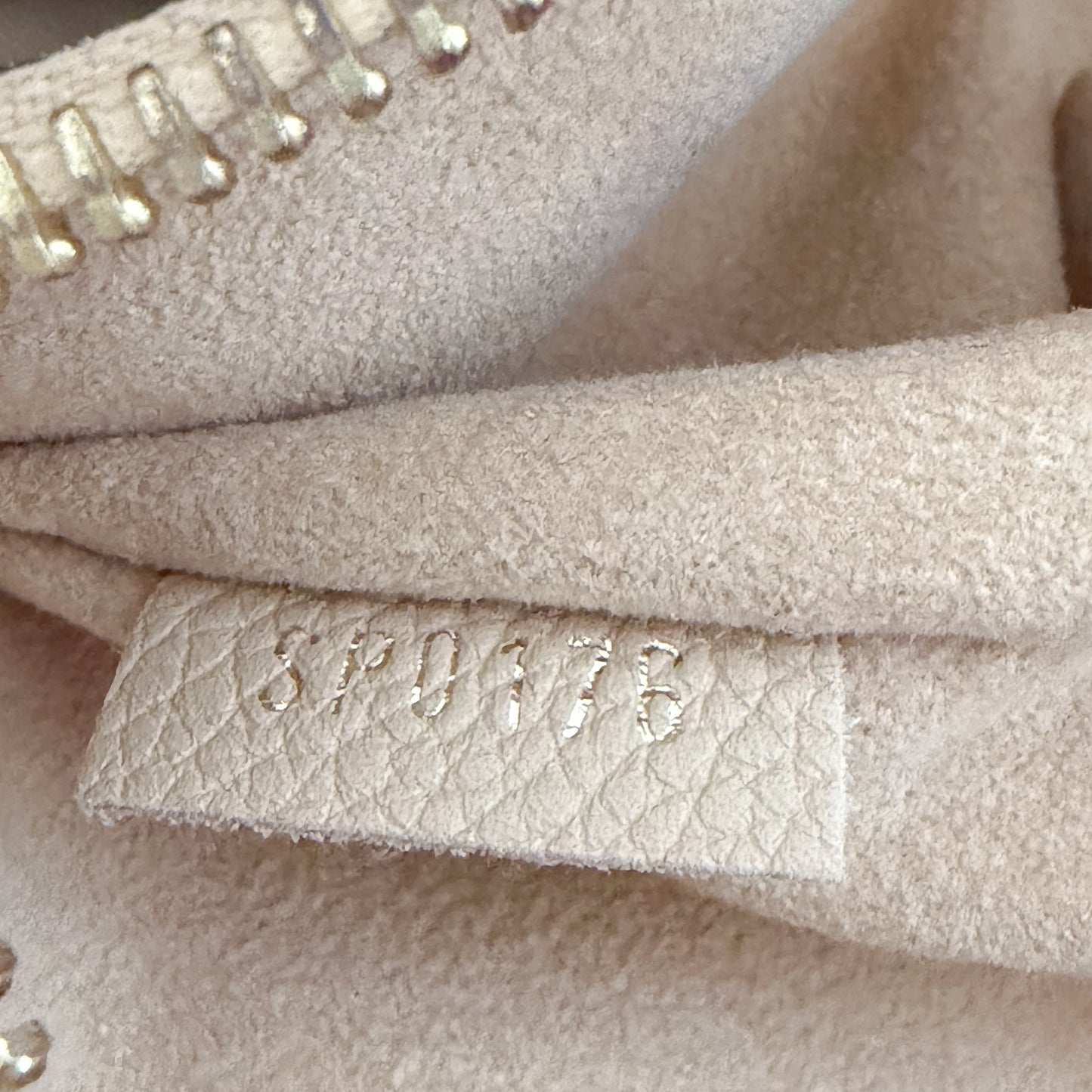 Louis Vuitton date code stamp close up reading SP0176 authenticity detail