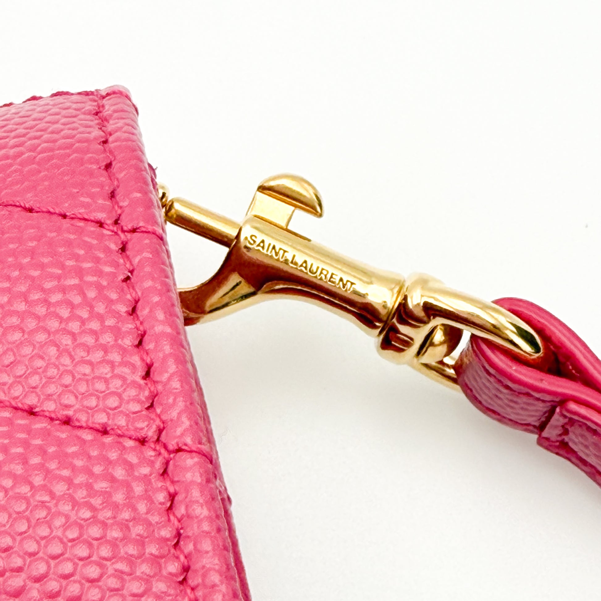 Preloved YSL Cassandre wristlet Fuxia Couture pink gold Saint Laurent engraved strap clasp detail