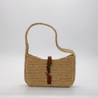 Saint Laurent Le 5 à 7 natural raffia mini hobo bag front view showing gold YSL monogram clasp