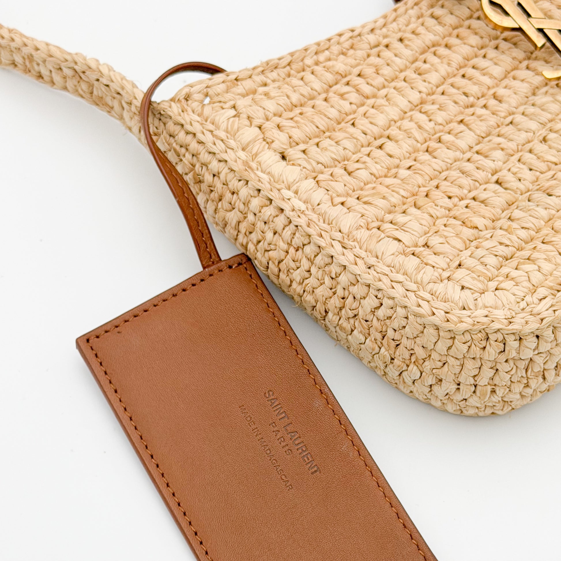 Saint Laurent leather tag close up stamped Made in Madagascar authenticity detail