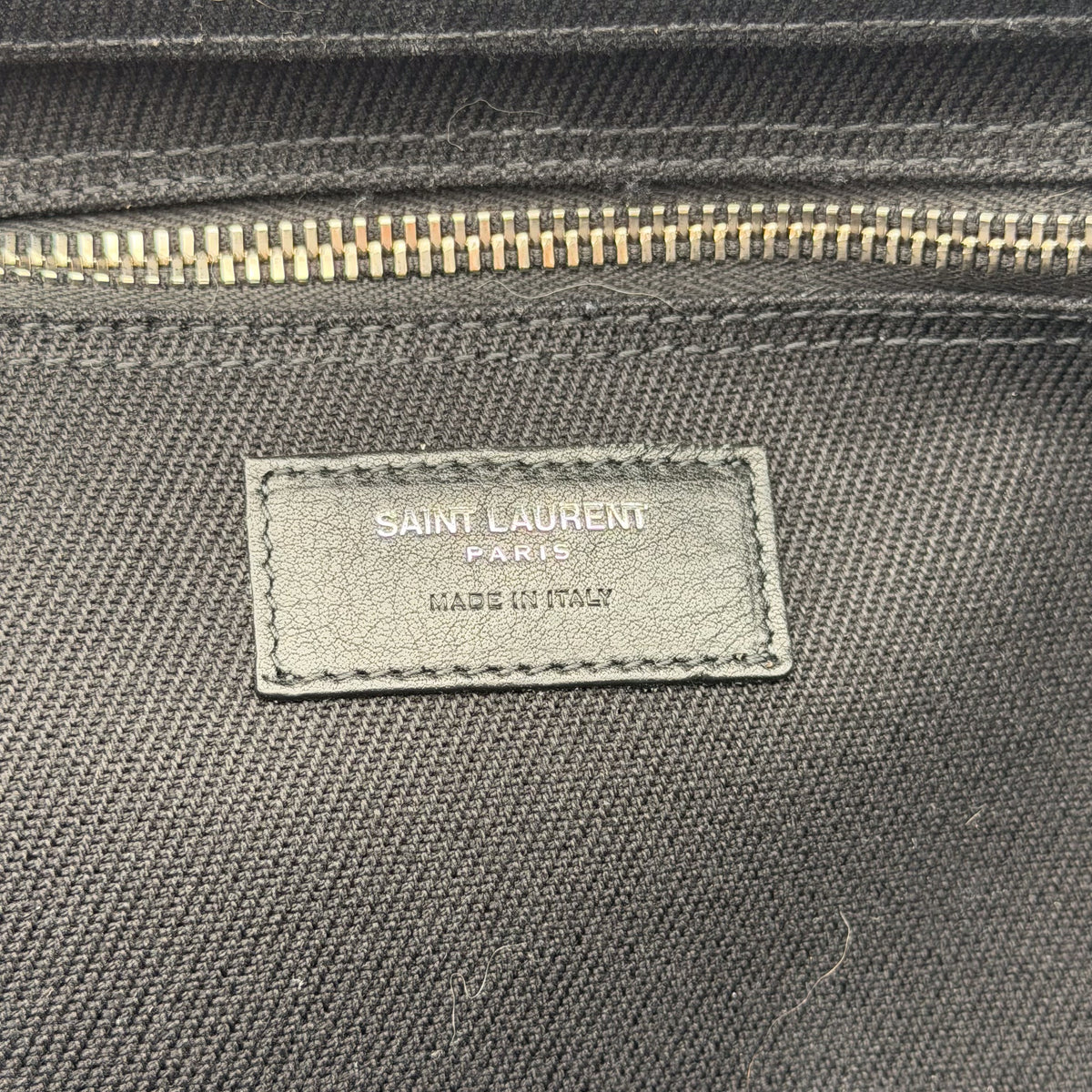 Saint Laurent Paris leather tab detail inside tote