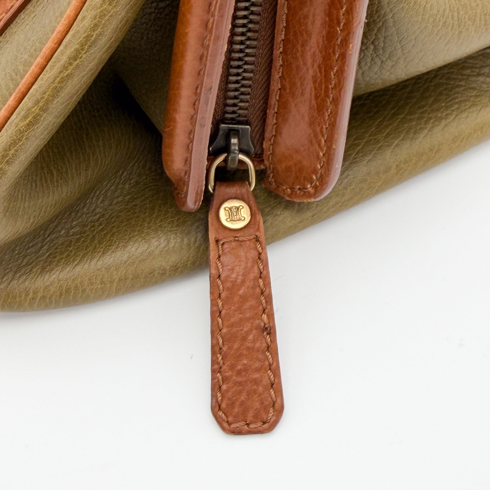 Used Celine Ella satchel front view showing buckle strap and brass plaque